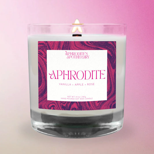 Aphrodite Candle from 'Aphrodite's Apothecary' on a pink and white gradient background.
