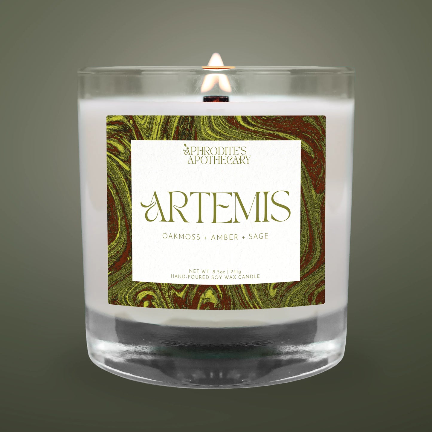 Candle with 'Artemis' label featuring marbled design on a dark background