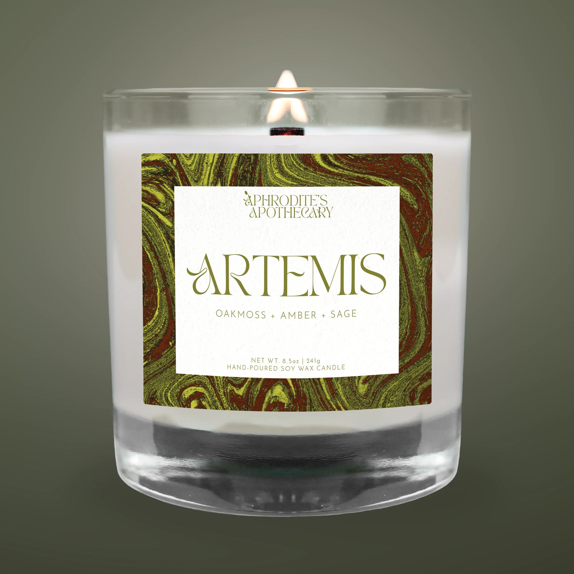 Candle with 'Artemis' label featuring marbled design on a dark background