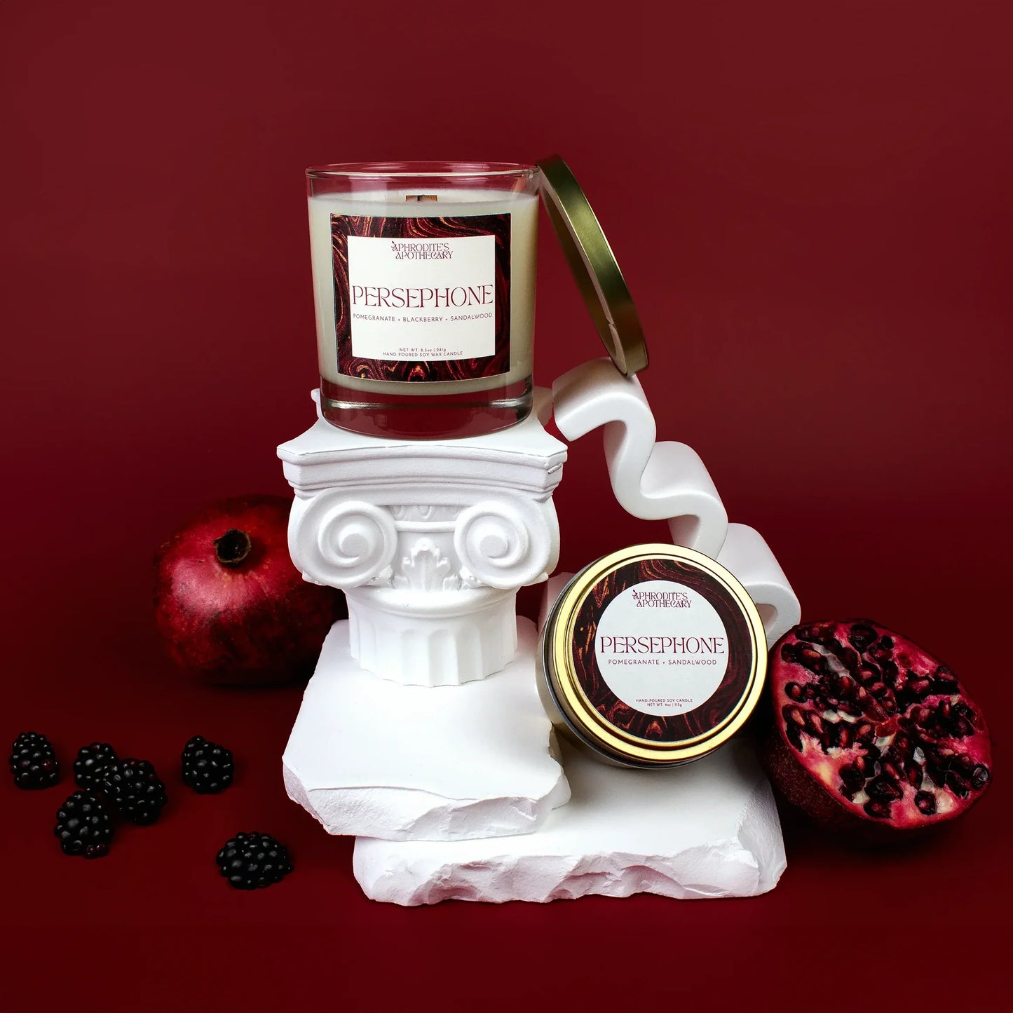 Persephone goddess candle with pomegranate and sandalwood on altar
