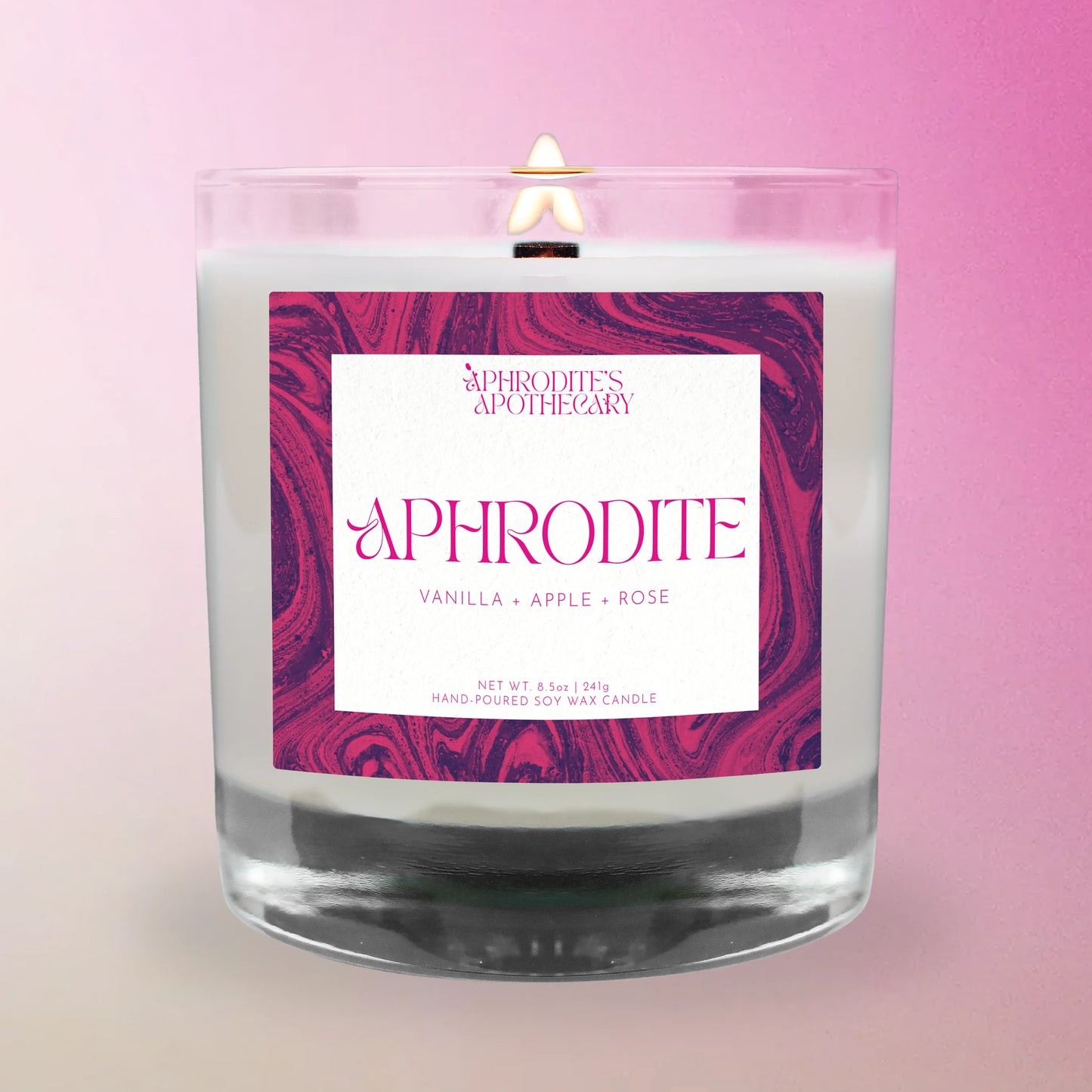 Aphrodite Candle from 'Aphrodite's Apothecary' on a pink and white gradient background.