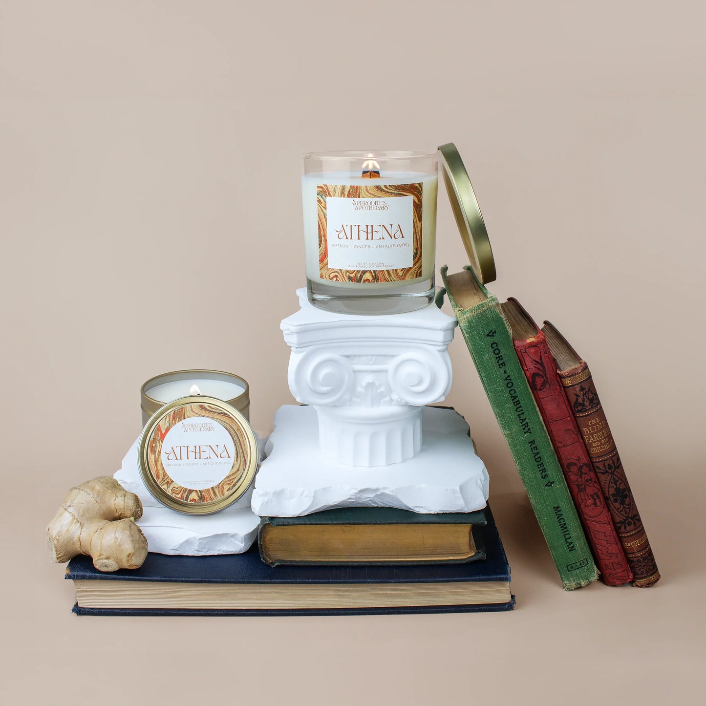 Athena Candle 8.5 oz and Athena Candle 4 oz on Greek themed photo set with antique rare books and ginger