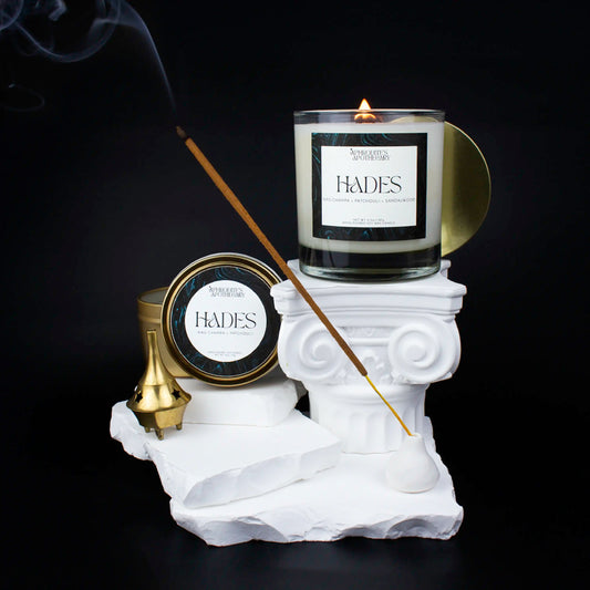 Hades Candle 8.5 oz and Hades Candle 4 oz on a Greek themed photo set with nag champa incense sticks and smoke swirling about